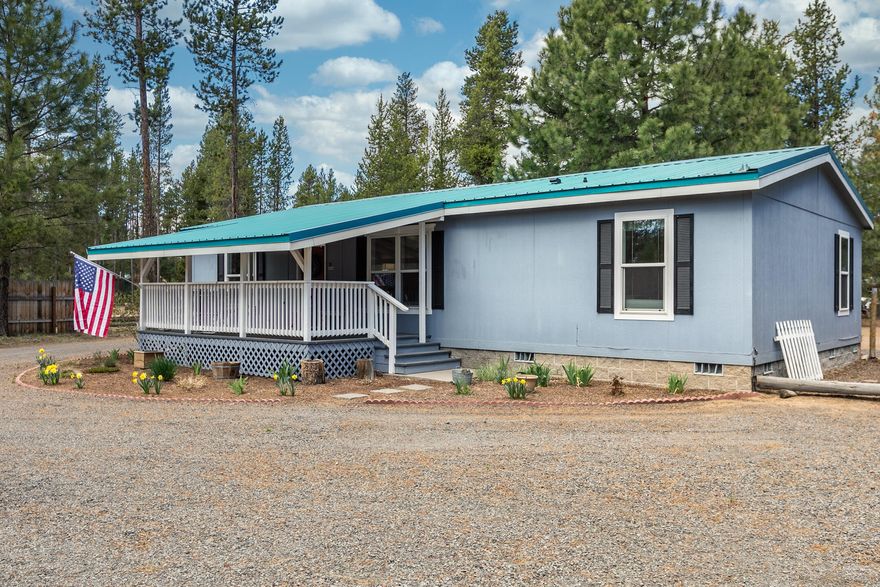 Down a sunny gravel road, deep in Deschutes County sits this lovely, well maintained home with a cozy propane stove, covered front porch, and berry patch, just right for The Three Bears....or more! Come find that little piece (1 acre) of heaven to call your own! Complete with separated primary bedroom suite, vaulted ceilings, white cabinets with lots of storage and newer appliances. Detached 2 car garage and additional out building/shed and 2 Full RV spots for all the friends and relatives to come and visit. Metal Roofs, property is fully fenced and gated.  On private well/standard septic, both trouble free! Easy landscape to maintain, with some planted areas and natural pines swaying in the breeze.  Within a mile of La Pine State Park for recreation along the Big Deschutes.