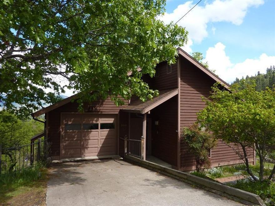 This is the first time this view property has been on the market. The home is designed to take full advantage of the outstanding view of the valley. There are 2 bedrooms and 2 baths on the main level with refinished hardwood floors. This level has a unique passive solar wall plus skylights for the hall. Downstairs you'll find 1 bedroom and bath with family/living room and a fireplace. There is new carpet and vinyl, with wood floors in the bedroom. Utility area could make a convenient second kitchen area for a two-family setup. Check out the second passive solar wall. The tiled atrium is a great place to enjoy your plants all year round. Fruit trees and garden areas will provide hours of enjoyment on this large .27 acre lot.