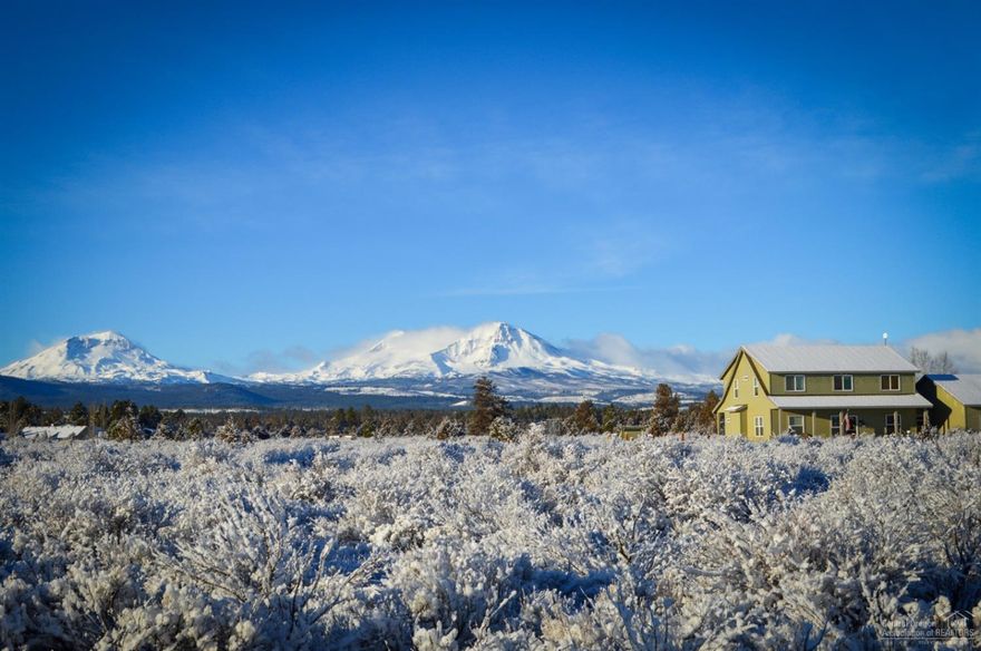Front porch sunrises and back patio mountain sunsets - it doesn't get better than this! Panoramic mountain views from the large windows in the beautiful white kitchen with wine fridge and walk-in pantry. Extra tall windows in adjacent sunroom let you enjoy that outside feel all year long! Huge bonus area upstairs with 3 large bedrooms and two bathrooms. Main level master with walk-in closet and ensuite bath. 3 car garage, RV cover, chicken coop/run, 1 fenced acre, horse shoe pits, fenced garden beds and more! Home warranty included.