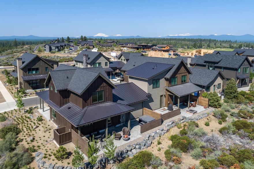 Here's the one you've been waiting for! Highlands Ridge was designed for buyers looking for affordable luxury in the heart of  the Tetherow resort community. The Manzanita Plus plan offers a covered front porch & spacious covered patio for enjoying outdoor dining, gatherings around the firepit & relaxing in the salt water hot tub.  The thoughtfully designed plan features 1652 sq ft of living space with beautiful hardwood floors through-out. Main level great room, dining area and kitchen w/center island, high-end appliances, large walk-in pantry and work space. Upstairs, two full suites offer privacy & expansive territorial & mountain views of the sunrise and the sunsets.  Spacious garage with built-in cabinets//workbench. In pristine condition & ready for new owners to enjoy the Central Oregon Lifestyle. Ideal corner lot across from the homeowner pool & close to hiking & biking trails, Mt Bachelor, River & Downtown.