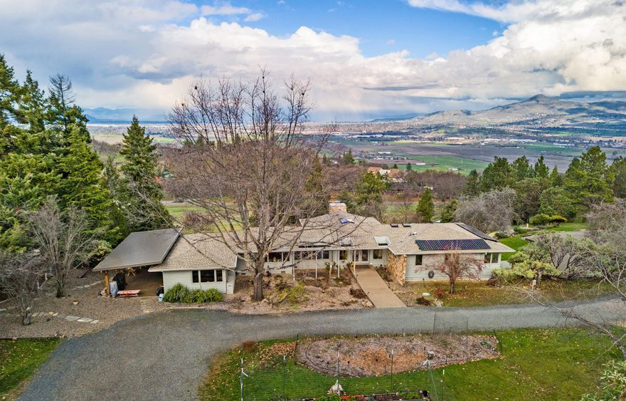 Boasting a stunning 3-bedroom, 2-bathroom residence spanning 3,392 square feet, this architectural masterpiece has a mid-century modern feel. Designed by David Strauss and positioned to enjoy amazing views on 5 acres.
Skylights & large windows bathe the living room in natural light, accentuating the beauty of hardwood floors and an array of modern features. A certified wood stove insert adds charm and warmth, quartz countertops, newer appliances, a washer and dryer, range, hood. 
This property goes beyond the ordinary, showcasing a commitment to sustainability. A 4500-watt solar system powers the essential loads during outages, also ensuring lower power bills from $13.00 - $200. Thousands of gallons of rainwater are harvested through state-of-the-art catchment systems.  An RV garage w/ 60 amp service plus an  underground propane tank and outbuildings for firewood storage. A new roof, HVAC and fresh paint inside and out make this a turn-key home.  Call your Realtor for an Appointment