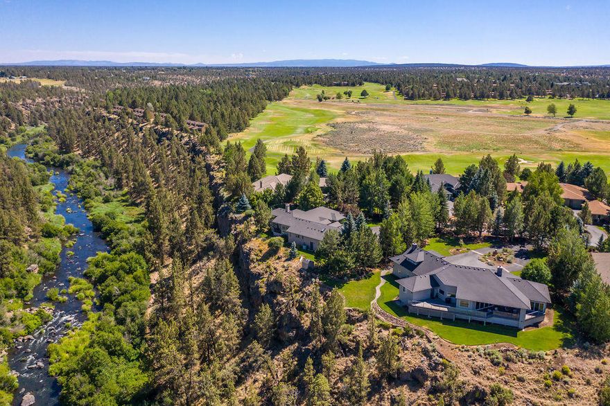 Introducing the rarest of all Central Oregon properties, a river front home!  Even more rare, this home features scenic, uninterrupted views down a long length of the Deschutes river from its perch above, the bubbling flow of the water and the trail along it beckoning you to come closer.  Sip coffee as you lounge on one of several decks, or snuggle up with a good book in the main living area with floor to ceiling windows, either vantage point will not disappoint as you watch eagles and osprey fly by or dip down in to the river for an aquatic snack. This very special property features spectacular views, immaculate landscaping, and a spacious and thoughtfully laid out home.  Located in a tranquil gated corner of Eagle Crest, this estate affords it owners all the amenities a world class resort has to offer, with views few can boast.