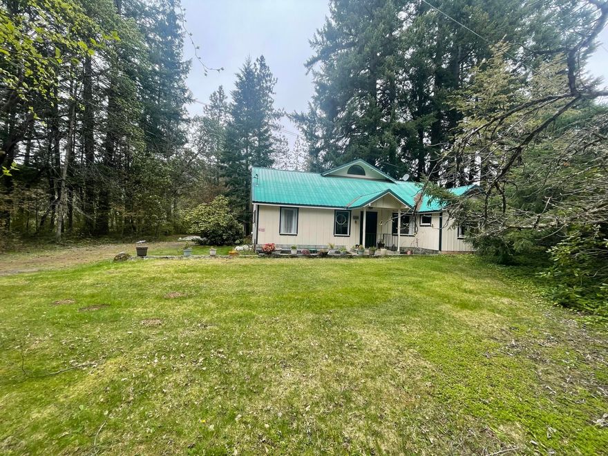 Incredibly charming 2 taxlot property w/ multiple outbuildings! The home is nestled on a flat .91 acre taxlot & offers a detached garage, covered outdoor work space, workshop w/ loft, lockable storage room, covered hot tub space, flat usable space for a lush garden as well as a separate art studio or perfect space to practice yoga or to just read. The additional 1.06 acre taxlot is wooded & provides a nice buffer for privacy. The home boasts an open floor plan w/ 2 bedrooms & a bathroom on the main level and upstairs you will find a finished attic bedroom w/ a big skylight & full bathroom. Glass doors open up from the balcony & you'll just love the views, peace and quiet this property offers. Metal roofs on all buildings- Don't miss out on this gem!