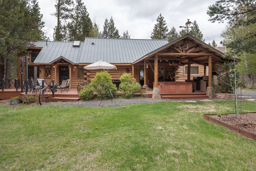 Cabin in the woods! Private and Natural setting. Custom log home its the perfect get away or full time living.  Open floor plan with wood accents, wood floors.  Vaulted ceilings in the master suite with access to the expansive decks.  Sitting/TV room off the great room. Loft sleeping porch and an additional bedroom upstairs. Updated kitchen with SS appliances. New mini-split heating /cooling system. Outdoor entertaining includes an outdoor kitchen, covered porch, hot tub, deer fencing for your garden. Artistic touches everywhere you look. All this is situated on a nicely treed .45 acre lot. An additional .48 acre lot (lot 10)  is included with storage/shop and carport. Only a block away from the river.  This home is 
turn Key ready for you.