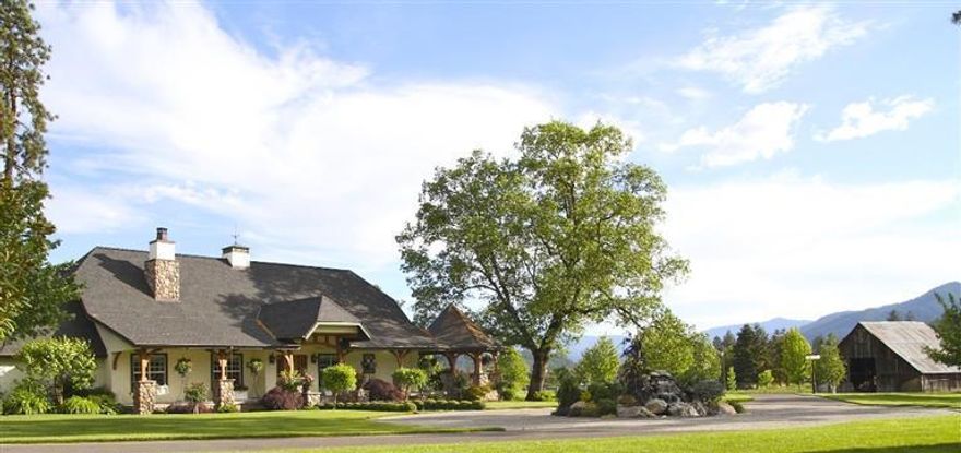 Applegate Valley Estate in the heart of our Wine Country! The custom home, guest cottage, 2000 s/f patio with outdoor kitchen, and covered decks rest amongst exquisitely landscaped grounds with 3 acre bass stocked lake, barn, orchard, and 6+/- acre producing vineyard. This incredible estate offers the ultimate wine country lifestyle with ideal location, setting & infrastructure for winery & tasting room. Current plantings are sufficient to produce approximately 1200 cases of wine. Additional vineyards can be planted to total from 10-15 acres. A Grower sales privilege license can be obtained allowing the grower to sell wines retail, wholesale, & export''. Wines can be made by one of the local wineries if desired. The Lake & lakeside park with tree lined walkway & maze is designed (including water & power) for a lakeside gazebo, glass house or a tasting room tucked back among the large oak trees. Sale subject to completion of lot line adjustment to incl aprox 24 ac.