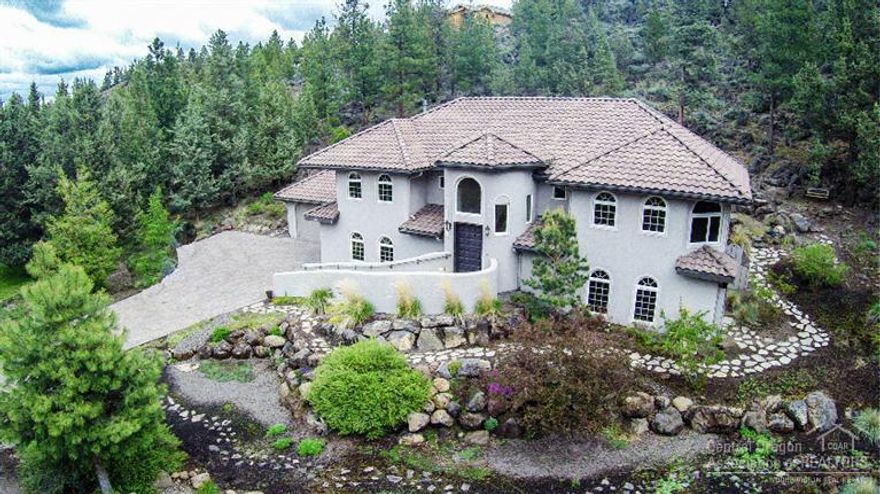 Contemporary Spanish style home nestled into the hillside overlooking Awbrey Glen's 12th Fairway. Builder's custom home, ICF construction, extensive cabinetry & woodwork, Great Room style living. Chef's kitchen w/NEW expansive granite counters & bar looks out to living area & floor to ceiling gas fp. Main level executive office w/fp & western views. New tiled Master Bath, garden tub in 2nd Master. Built-ins in each room for easy organization. 1300+sf garage, family room & wine grotto. Too much to list!