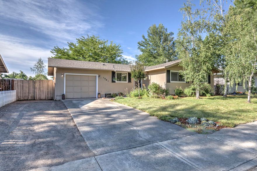 Home Sweet Home!  Lovely East Medford neighborhood perfect for evening walks and family barbecues.  3 bedrooms, 2 bathrooms with an open spacious floor plan.  Kitchen features a wonderful island and stainless appliances.  Back yard is huge and offers mature landscaping with beautiful flowers and an amazing shade tree.  Hot Tub is included.  Space for small rv parking.  This home is move-in ready and waiting for you.