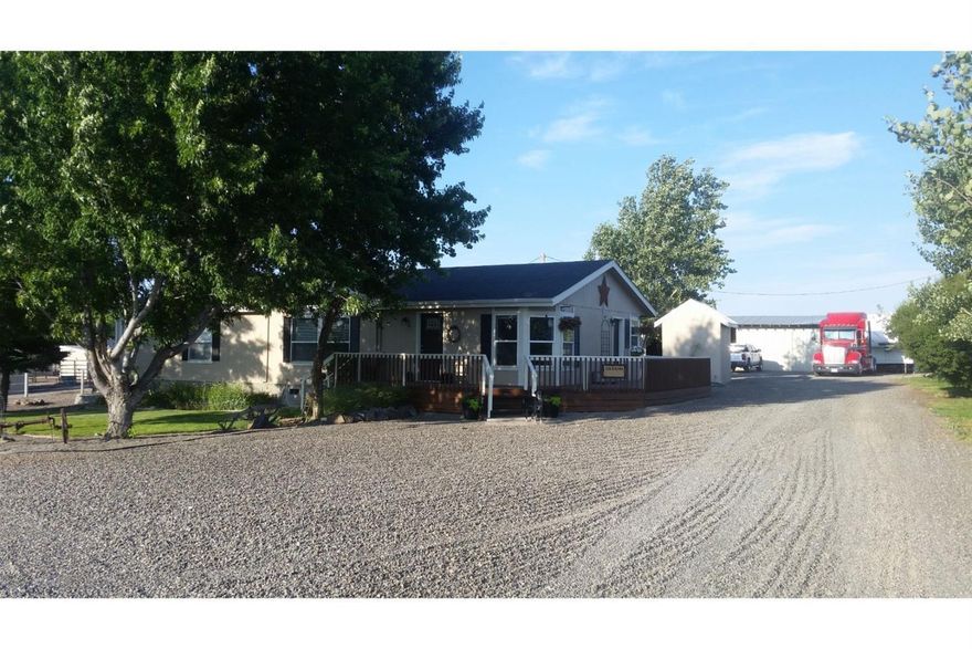 Pride in ownership on this 4.85 acre horse property with 4.4 acres of irrigation. Property is fenced with Shockline Flex Fence hot wire fencing and cross fenced with an arena, tack room, carport and shop area that has concrete floor and power and a storage container behind shop. Inside you will find lot of updates throughout including newer kitchen appliances and a large walk in shower in the master bathroom, nice sized bedrooms and a large living room with views over the property. Additional RV parking at the road has water.