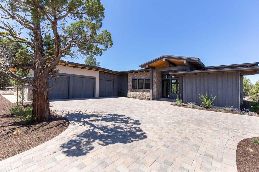 This stunning single level contemporary home captures you with its open plan & expansive views of the Nicklaus Signature Golf Course. Mountain modern accents throughout include wide plank White Oak Hardwood floors, walls of windows & oversized glass doors, a full height stone Fireplace & an abundance of custom cabinetry. Fantastic  open kitchen with Island eating bar & Pantry. Two Master Suites open to the rear patio. Third bedroom for guests or office. Oversized 3 car garage with finished Epoxy floor. Lutron automated system. Spacious covered patio w/ Built-in BBQ, Firepit & Hot Tub for gathering & relaxing under the stars. Located behind the 2nd private gate in The Estates at Juniper Preserve, a serene, private setting within the Resort. Enjoy all the luxury amenities of the resort...Members Club, 2 Championship Golf Courses, Dining, Pools,Spa, Fitness Center, Dog Park and more! Seller includes the transfer of the Full Pronghorn Premier Club Membership at closing.