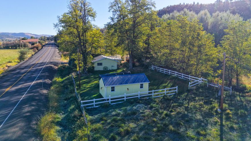 he property spans 1.08 acres and features two fenced pastures with water rights from the ditch. It includes a charming 1900 stick-built residence offering 816 square feet of living space. The kitchen has been updated with hickory cabinets, Formica countertops, and new stainless-steel appliances, all included in the sale. A washer and dryer are also provided. For heating, the home is equipped with a propane furnace, while a swamp cooler and a window AC unit are available for comfort. The flooring throughout the home consists of tile, hardwood, and laminate. Freshly painted interiors enhance the inviting atmosphere. A new tub surround was installed with glass sliding doors.
Additional features include a 7' x 12' shed for extra storage and a 12' x 24' hickory shed with power and some loft storage. The property boasts various plants, including peach, cherry, plum, blueberry, raspberry, and blackberry bushes, as well as ornamental plum, weeping cherry trees, irises, and flaming bushes,