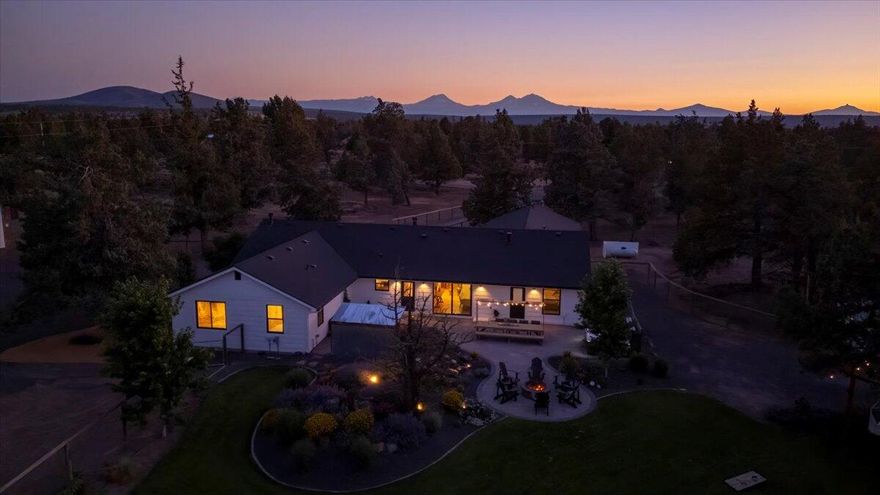 Welcome to your private oasis minutes outside the city limits. Nestled on 4.84 beautifully landscaped acres. This property offers the perfect blend of modern rustic living, outdoor serenity, and versatile functionality. A true gardener's paradise and entertainer's dream featuring a large paver patio, cozy firepit, inviting hammocks, a soothing water feature. The lush grounds include blooming flower beds and a greenhouse, ideal for green thumbs and peaceful moments alike. Animal lovers will appreciate the cross-fenced pastures, barn with paddocks, and dedicated chicken area. A large 4-bay shop with an amazing flex space area for guests. RV pad with full hookups. Inside, the home exudes modern rustic charm with upscale custom finishes throughout. The chef's kitchen includes a hidden walk-in pantry and flows into a bright, open living space with vaulted ceilings, exposed beams, and a stunning floor-to-ceiling fireplace. A big 3-car garage for all your gear.