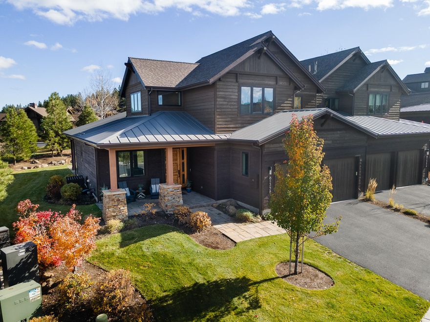 Set on a large corner lot within the exclusive gates of Tetherow, this impeccably maintained Triple Knot townhome offers the perfect blend of luxury, comfort, and convenience. Designed in Northwest contemporary style, the home is filled with natural light and upscale finishes. Features include a main-level primary suite, 2 ensuite bedrooms upstairs, home office, vaulted ceilings, a striking floor-to-ceiling fireplace, hardwood floors, new carpet and paint, and attached 2-car garage. Perfect for entertaining, the gourmet kitchen is outfitted with dual islands, Jenn Air appliances, custom cabinetry, and quartz counters. Enjoy seamless indoor-outdoor living with a covered patio for dining and a Cement Elegance gas firepit for cozy evenings. HOA-managed exterior & landscaping is ideal for a lock-and-leave lifestyle. Tetherow amenities include 2 pools, lap swim, fitness facilities, and social events. Fantastic westside location with easy access to recreation, dining, shopping & more!