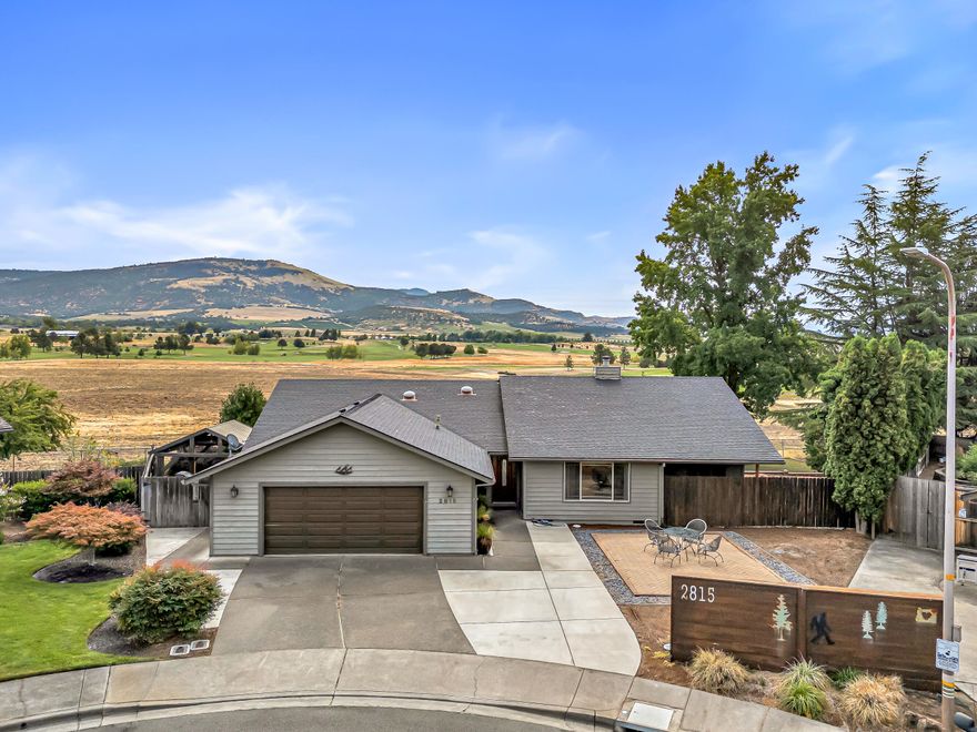 Amazing Centennial Golf Course views span the entire back of this single-level East Medford home on a huge .28 acre cul-de-sac lot. What an incredible location! Packed with upgrades including a remodeled kitchen w/granite, stainless appliances, gas stove, moveable island, and custom lighting. Vaulted ceilings, solar tubes, newer interior doors, laminate & vinyl plank flooring, newer heat/air + more. Spacious living & family rooms offer great flow (plans included for guest or in-law quarters). Both bathrooms have been beautifully remodeled with granite, tile showers, and more. Primary suite has golf course views. Step out back to a 480 sq ft deck, no-mow yard, water feature, and 3 gazebos. Oversized garage with sink, toilet, attic storage, 3-car driveway, and golf cart/ATV parking behind fence. Must tour!