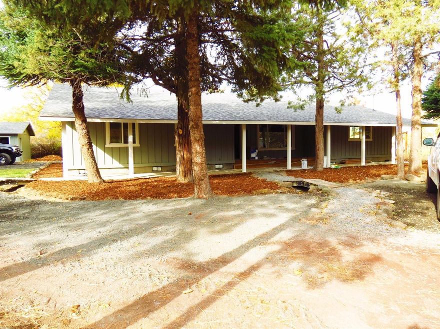 Talk about seclusion this home has it. Sitting at the end of the lane is this 2094 sq.ft. 3 bedroom, 2 bath home that has new laminate flooring, carpet, roof, windows, tiled kitchen counters, large deck, covered entry, master bath with double sinks & tub/shower, stainless appliances, separate garage with new automatic door. Pantry in kitchen. Walk in closet with plus a extra closet in the master bath. Bar in the corner. Pellet stove. Newly painted. Large 0.4349 acre lot with room for the RV's. Move in ready