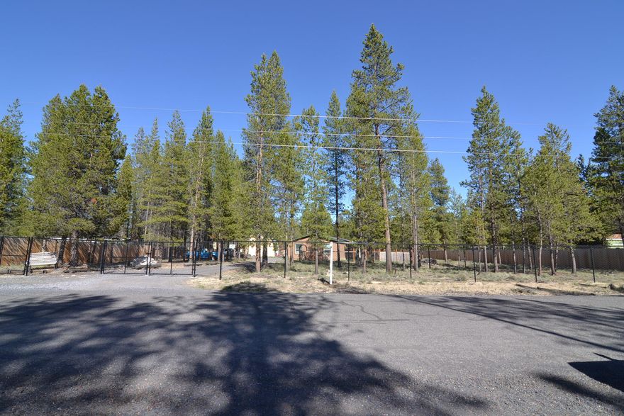 Tranquility and pine trees on 1 acre fenced and gated!  This 4 bed, 2 bath 1728 sq ft home features plenty of space to relax.  Large open living room with vaulted ceiling and a charming wood burning stove to keep you cozy in the winter, with a spacious kitchen and dining area for entertaining.  Step outside on the paver patio and relax in the hot tub under the gazebo.  Fenced raised bed garden and a fenced dog kennel, perfect for those with a green thumb and furry friends.  Gather around the firepit on cool evenings and make memories!  RV garage is spacious enough to store all of your toys and RV too!