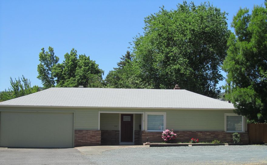 Clean Office is ready for business with waiting room and private conference/office with access door to the covered deck.  A few built in desks and room for at least 6 more desks depending on your layout and needs. Ductless mini split very efficient. Built in storage cabinetry. 552 Sq Ft. attached unfinished garage with cement floor that could be converted for additional office space.,  Check with city for all possibilities and uses. Structure sits at the rear of the property which affords ample parking for business uses. Property is partially fenced and has asphalt driveway.