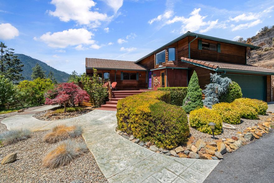 PRICED TO SELL! Beautiful 5-acre Jacksonville retreat.
Private paved drive leads to a 3-bed, 2.5-bath, 2,124 sqft cedar-sided home with wraparound deck and sweeping Applegate Valley views. Property includes BLM land behind, a professional grade pickleball court with covered patio, plus a small workshop and sauna. Inside features a wall of view windows, updated kitchen with stainless appliances and granite island, and a master suite with bay window, walk-in closet, and dual-sink bath. Also includes a versatile mother-in-law unit and a 2-car garage with storage. A rare, private getaway—schedule a tour today!