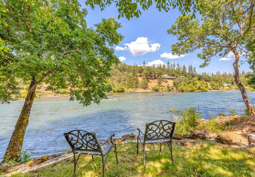 Vacation-like property in downtown Shady Cove on the Rogue River. Quiet street that all the neighbors walk. Great fishing hole for steelhead & trout from the sidewalk behind the house. 30 feet from the river you can relax on the covered porch & watch wildlife as the river flows by. This 3 bd/2 bath home has an open living room, dining room, & kitchen w/ breakfast bar. Granite countertops throughout. Custom cabinetry provides extensive storage. Primary bedroom has a custom walk-in closet. 3rd bedroom currently used as an office with built-in desk/cabinets & a separate entrance w/ its own deck. Separate hot tub cabana 14'x14'. Additional building with 2 story guest quarters has a large living area, bedroom, full bath, laundry, & an attached 11.5' x 40' RV garage. House & guest quarters each have a single car garage. Electric gate. Home has been upgraded throughout, incl. all new appliances & spa (2022), roofing (2017), hvac (2020), master bath & fixtures (2021), fencing (2023) & more.