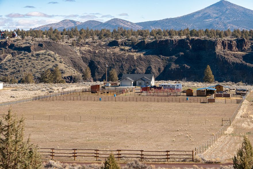 Don't miss your opportunity to own 10+ acres on the river at the edge of Crooked River Ranch! Beautifully maintained like new home ftrs a great room floorplan w/ vaulted ceilings & tons of windows for an abundance of natural light throughout! Kitchen ftrs large island w/ breakfast bar seating, plenty of prep & cabinet space, large walk-in pantry w/ built-in shelving, & spacious eating area. Large primary suite ftrs walk-in closet, private bath w/ dual vanities, & enclosed toilet area. Two add'l bedrooms share a full bath. Office/den w/ french doors or use it as a fourth bedroom. Oversized mud room & dual car garage. Crooked River is right out the back door! Outside you'll find: an arena 120' x200' with roping chute (option), 55' round pen, 8x12 tack room, 10x20 barn with two 10x20 attached equipment lean to's. 24x30, 20 ton hay barn. 2 double horse shelters with 4 horse pens. 2 cattle holding pens. Plus 2 fully fenced dry lots. Optional access to all CRR amenities! Live & play here!