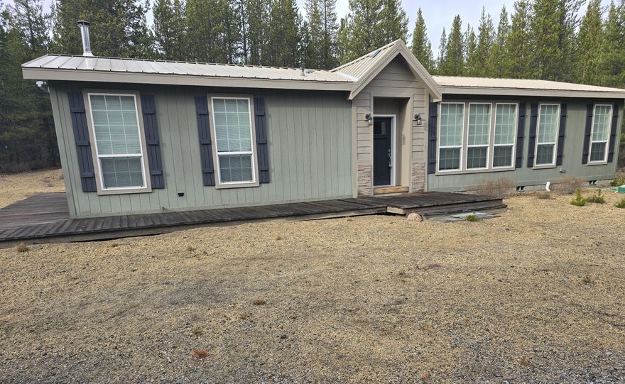 2017 manufactured home , 1,620 sq. ft., 2 bdrm 2 bath, 1.09 acres. Tucked away at the end of a quiet cul-de-sac in the desirable Two Rivers North subdivision, bordered by Forest Service land on two sides, offering privacy and a true mountain-living feel. Pride of ownership is evident throughout, from the well-kept grounds to the thoughtfully maintained home. A carport with an attached storage shed provides convenient covered parking, plus additional RV parking.  Turn-key & includes all furniture, snowmobiles, & now blower, making it ready for year-round enjoyment from day one. A durable metal roof, wood stove for cozy winter evenings, great well enhance both comfort & reliability.  Enjoy easy access to near by trails for endless outdoor adventures. Hemlock Creek is approximately one block away, and the Little Deschutes River runs through the subdivision. Owner Financing!