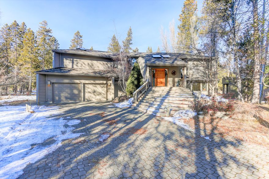Enjoy coveted views, through aspens & pines, of the mighty Deschutes River from nearly every room in this elegant 3 BR, 2.5 BA custom home that is privately nestled on a quiet lane on the north end of Sunriver! Reverse living features upper level, great room, primary suite, dedicated dining space, adjoining kitchen w/wet bar & breakfast nook. Cozy up to a crackling fire at the stone hearth under vaulted ceilings, wood beams, floor to ceiling windows looking out to extensive, 3 levels of decking that highlight the year round views and outdoor NW living. Lower level bonus room w/wet bar & exit to deck and hot tub level, 2 more BRs & shared hall BA. Newer ext/int paint, new front door & newer entry steps, EV charger, AC, entire rear deck redone within recent years, newer furnace. Located near Member Pool, Woodlands Golf Course & Cardinal Landing Bridge where you can launch a Kayak from the nat'l forest side or access miles of hiking/biking trails - your Sunriver ''dream home'' await