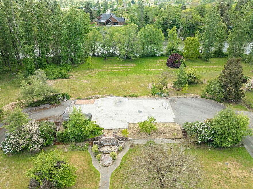 Stunning Level and Useable 1.04 Acres of Waterfront Land on a Lovely Stretch of the Rogue River. The River Frontage here is Low to Mid Bank and Stunning, with an Expansive Grassy Meadow Area between the Homesite and the River. Impressive On-Site Improvements are already in place, with Grid Power, Telephone and Other Utilities, Concrete Slab Building Pad, and an Installed Standard Septic System! Located down a Pretty Paved Private Drive with just a Few Homes. Legal Lot Determination on File. This is a Stunning and Impressive Parcel. There are VERY Few of these River-Front Properties remaining. TWO Additional Adjoining 1+ Acre Riverfront Parcels available also! One with a Large 1,728 Sq Foot Frame Built Shop and Drilled Well, the other a Vacant Unimproved Parcel. Discounted Price for Multiple Parcels Sold together. Perfect Opportunity for a Multi-Generational Riverfront Situation! Don't miss the opportunity to come see this Superb Riverfront Parcel.