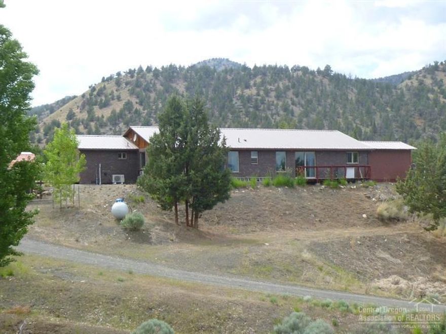 Spectacular views from this brick home and property with Bridge Creek running through the property.Many varieties of trees have been planted including fruit trees. 4 separate fenced garden areas. Over 13 acres planted in Orchard Grass Hay. Home has Bamboo Floors & Ash Cabinets in Kitchen Mitsubishi Ductless Heating & cooling plus a propane monitor heater and cadets in the bedrooms. Huge bonus room could be additional bedrooms. 28X40 insulated shop w/ water and 220 + a two story barn and other outbuildings.