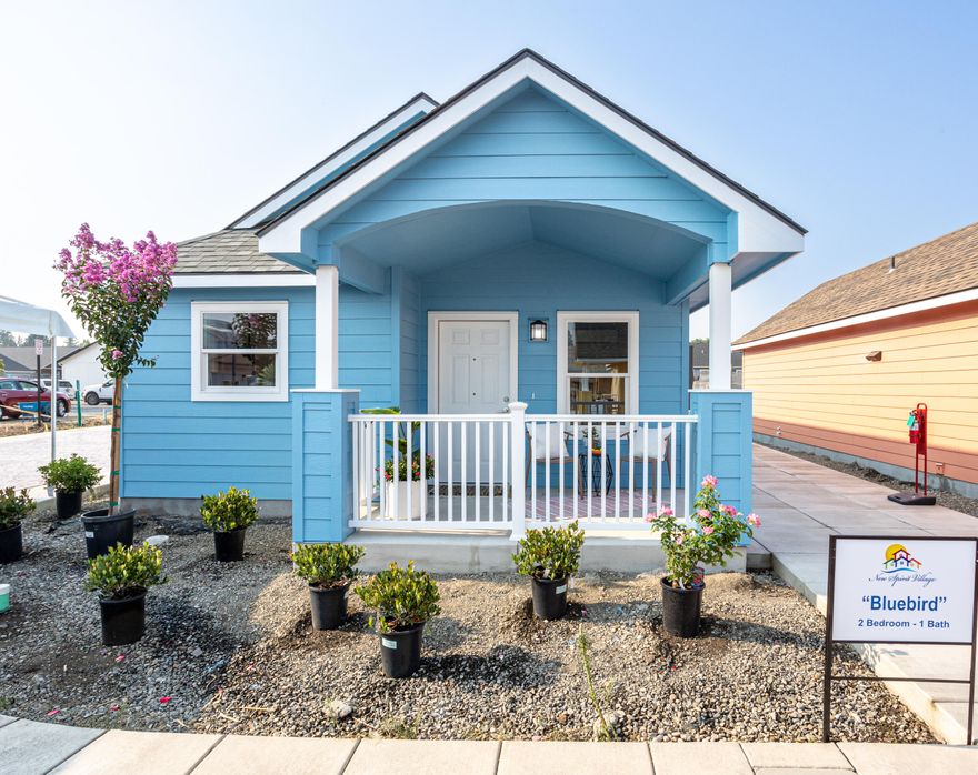 Open House Friday 1:00-3:00! Qualifies for Amplify Oregon—an equity-builder mortgage with no PMI, no funding fee, no down payment (100% financing), interest rates in the 4s, and a 20-year term. Meet the ''Bluebird,'' an innovative 2 bed/1 bath, single-level home in New Spirit Village. Energy-smart frame construction with a ductless heat pump, LVP throughout, and an open living/kitchen. Refrigerator, washer, and dryer included. Enjoy a private rear patio, fenced backyard with durable vinyl, and an exterior storage shed—great for bikes and tools. Adjacent to 8-acre Lewis Park with trails, playgrounds, splash pad, and a basketball court. New Spirit Village's pay-it-forward Community Land Trust keeps prices below market and preserves long-term affordability (resale, owner-occupancy, income, and other restrictions apply). Estimated completion 11/28/25; photos for illustration only. Tour the model today; ask how Amplify Oregon can help build equity faster and lower monthly costs.