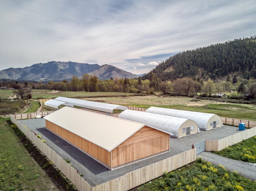 An absolute bargain for such a comprehensive property! Located in the heart of the Applegate Valley with renowned soil, sun and water, no expense was spared when building this farm. At +/- 10.53 EFU acres, the property includes 1,600 amps of 3 phase power, Applegate River irrigation with a 1901 priority date, nearly 7,000 SF insulated and climate-controlled warehouse, 2 fully automated internal frame light dep greenhouses with raised beds and automatic root zone heating, 30 x 300 and 30 x 96 fixed frame greenhouses, water storage pond plus multiple tanks, 2,000 gal of propane storage, 9' security fence and +/- 6 acres of pasture to expand your operation or build a home. All work was completed to professional standards and is permitted with Jackson County. Most equipment such as lights (~150), mixing stations, dehumidifiers, etc are included, but the owner will remove them if you want a shop and land but don't plan to farm. Owner carry considered with 1/2 down. Inquire for more details.