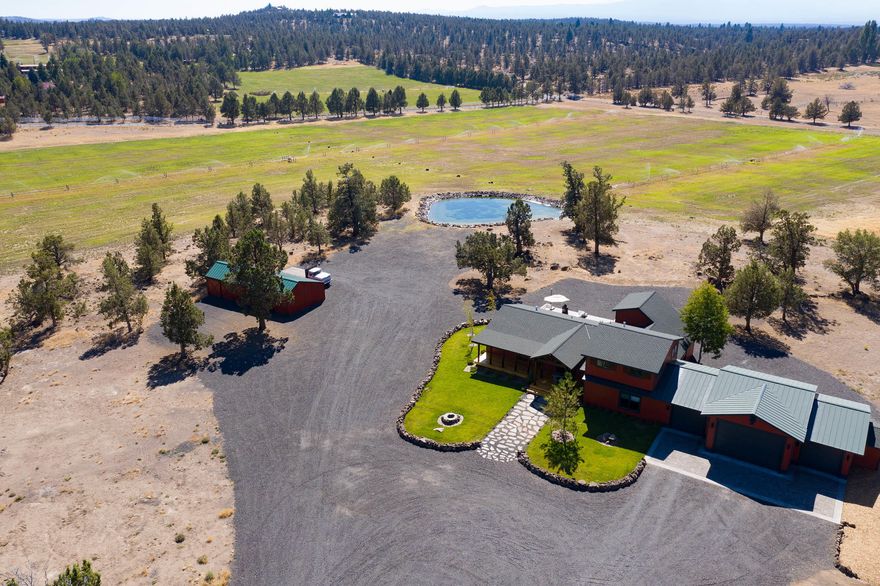 Located on 35 peaceful acres in the highly desirable Tumalo area of Bend, this contemporary farmhouse, sitting behind the gated drive, provides supreme privacy & stunning panoramas of surrounding acreage & Cascade Mountains. Lavishly renovated, home features wood flooring throughout, great room w/ fireplace, dining room & gourmet kitchen w/ double ovens, copper basin & prep sinks, slab-granite topped island/brkfst bar. Master suite w/ vaulted ceilings, bath w/ free standing tub & dual sinks, as well as ultra-private get-away w/ wet bar, fireplace & mountains views; the perfect owner's suite office, exercise studio or den. Spacious family room & two addtl. guest suites on main plus another two up provides ample space for family & friends.
Large 4-car garage & separate barn for animals or recreational toys of all kinds.  To complete this wonderful offering, property is currently in hay production.  Far from the hustle & bustle of the city, this residence is the ideal retreat from it all.