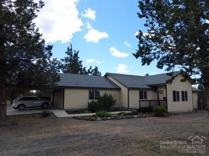 Country Living includes plenty of room on rare 2.33 acre clean lot! Lovely huge garden spaces w/greenhouse, to grow your own food & flowers. Home was completed in 1995 as a 1 bed/1 bath, w/a permitted addition adding 2 more bdrms & another full bath in 1999. Brand new roof May 2016! Lovely vaulted great room w/Whitfield pellet stove. 2 car attached garage, plus a covered carport, shop w/electric, fire pit, RV areas & huge covered back patio for relaxation & entertaining. All minutes away from Bend's best!