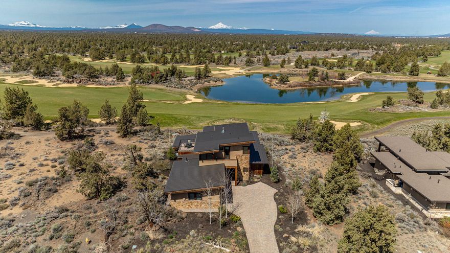 Discover the pinnacle of High Desert living at this exquisite single-family home bordering Pronghorn's Tom Fazio course in Central Oregon. Three luxurious suites, upscale finishes, and breathtaking views of the golf course, lake, and Cascade Mountains await. Enjoy seamless indoor-outdoor living with high-beamed ceilings, tile and hardwood flooring, and a spacious covered patio featuring a fireplace and built-in BBQ. The upstairs Studio Suite offers two private balconies with panoramic vistas. With access to Nicklaus and Fazio golf courses, a Private Member Club, 55,000 sqft Club House, pools, fitness center, spa, and fine dining, Pronghorn offers a lifestyle of unparalleled luxury and leisure.