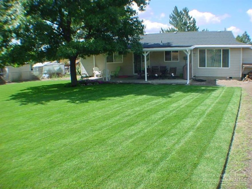 Great home on almost a half acre lot! totally updated interior.... new doors, windows, blinds, paint, cabinets, hardwood floors in the kitchen/dinning area, carpet, and tile. also new motor in furnace, new hot water heater, new ceiling insulation, insulated garage, and new concrete septic tank. new sod and sprinkler system in the back yard to compliment the large covered patio. front and back yard are fenced. Don't miss this one at this price.