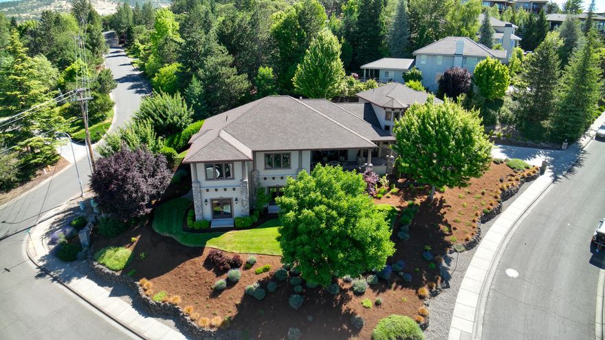 Step into luxury living at Cherry Lane Estates! This exceptional 4,620 sqft home offers 5 bedrooms, an office, 4.5 bathrooms, and an array of high-end features. Take in stunning valley views from over 1,000 sqft of covered outdoor spaces, complete with an outdoor kitchen, fireplace, ceiling fans, and two motorized sun shades. Perfect for entertaining, the home includes a theater, upper and lower living areas, wet bars, and a whole-house audio system. The gourmet kitchen is equipped with Jenn-Air commercial appliances, granite counters, and a built-in radius banquette. The primary suite features breathtaking views, natural light, a luxurious freestanding tub, and a walk-in closet with direct access to the laundry room. Situated on a beautifully landscaped oversized double corner lot with a tranquil pond and dual waterfalls. Additional highlights include a 3-car garage, central vacuum system, and a craft/hobby room on the lower level. Owner is a licensed real estate broker in Oregon.