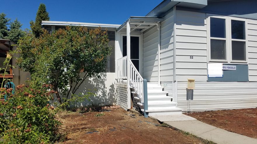 Want a freshly painted move-in ready home? Here it is! This home has kitchen & bathroom upgrades including new refrigerator, new range & hood.  Kitchen has an abundance of cabinets including a good-sized pantry AND breakfast bar. Separate laundry room. New flooring throughout! New light fixtures. Double pane vinyl windows throughout. Forced air heat/air conditioning. Want to sit outside?? There is a 16' x 12' screened-in patio for relaxing or entertaining!
Heat pump & water heater replaced within the last 4 years. 
Outside there is a spacious 2-car carport plus a 16x10' freshly painted storage shed...with electricity!   
Talk to Park Manager to verify the two pet under 20 pound limit as well as the lower than average $553 monthly space rent (that includes water, sewer and garbage).
Don't wait! This home is 'Move-in Ready!'