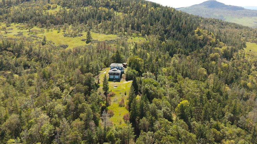 Rare opportunity to complete a 193.29 acre estate. Construction started in 2001 on a 2213 sq ft 2 story plus ground level 2 car garage & basement wine cellar. Owner/designer vision was to have a private estate/vineyard. Knoll homesite w/sweeping views to NW across Antelope Valley, Agate Lake & Table Rocks & plus nice sunsets. East w/peak view of Mt McLoughlin. South Cascade foothills. Interior currently unfinished. Main living level w/270 degree views from great room w/center Scandinavian fireplace, kitchen & dining areas, w/ bedroom area separated by full bath to bonus/office or maybe 3rd bedroom? Upstairs is a primary suite w/270 degree views w/bathroom & closet, plus balcony to South. Exterior partially completed w/cement board siding. Driveway entrance to residence area is via Wren Ridge. Northwest corner of property is adjacent to Burlwood Road w/possibility for additional access. Potential to subdivide was discussed w/Jackson County Planning in 2022 - has possibilities.