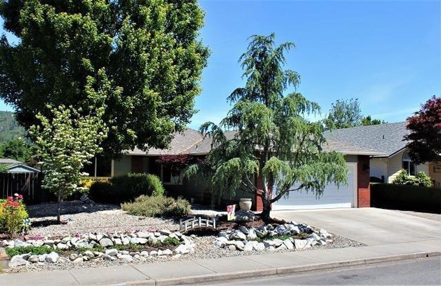 Contemporary 3 bed, 2 bath, 1312 square foot home in a great neighborhood. Close to All Sports Park'' and the Rogue River. This split bedroom home is meticulously cared for and features vaulted ceilings and French doors leading out to a beautiful deck with views of Dollar Mountain. Property has low-maintenance landscaping with various mature trees and berry bushes. 10 X 20 shed in back yard. Great sun exposure for anyone that gardens. Right side of driveway could be used for a small RV/boat or additional parking. Close to town. . Seller is offering a 1 year basic First American Home Buyers Protection Warranty.