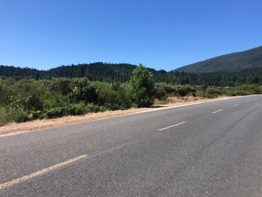 Attention developers.  This 8.46 acre lot is zoned single family residential with development potential for lots as small as 7000 sq ft.  Close proximity to the stunning Illinois River, with beautiful mountain views, and sits amongst the new Pomeroy River Estates and Illinois River Estates with individual houses selling for upwards of $300,000.  The utilities run to the property line, and it has paved roads on 3 sides.  Great potential for a new housing development. Buyer to do their own due diligence.