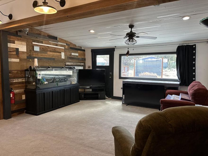 Financing available!! Escape the ordinary with this priced to sell,  older manufactured home set on nearly 2 fully-fenced and gated acres, just minutes from town. Recent upgrades include a new roof, septic system, furnace, and appliances (all withing the last 5 years). providing peace of mind while preserving its rustic charm. A spacious detached garage/workshop offers room for hobbies, storage or serious  tinkering, and the community water system keeps utilities simple. Surrounded by open space and visited often by local wildlife, this property is perfect for those seeking quiet, elbow room and possibility. Whether you renovate, build new or simply enjoy as is, this little slice of the country is full of potential. There is even a fire hydrant on the property line!  SOLD AS-IS. Financing Available!!