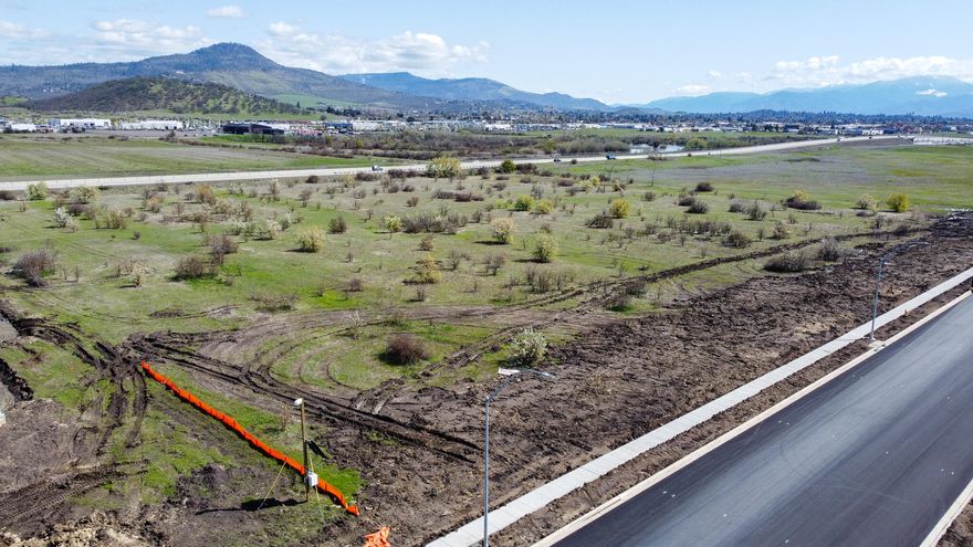 Certified industrial ''shovel ready site'' by State of Oregon in 2018 #028-04, over 150-page research report vetting the property conditions much as a buyer would do.  Industry Drive is a designated Industry Collector street and designed to continue southerly to intersect with Coker Butte Road, now extended under the Highway 62 bypass.  Owners have completed the southerly extension of Industry Drive to the southern line of this lot--curbs, gutters, pavement.  Nearby owners include American Tire, PepsiCo and Medford Water Commission..  This parcel is well suited for more rapid facility construction and operation than most others of similar zone and size.  Call for information!