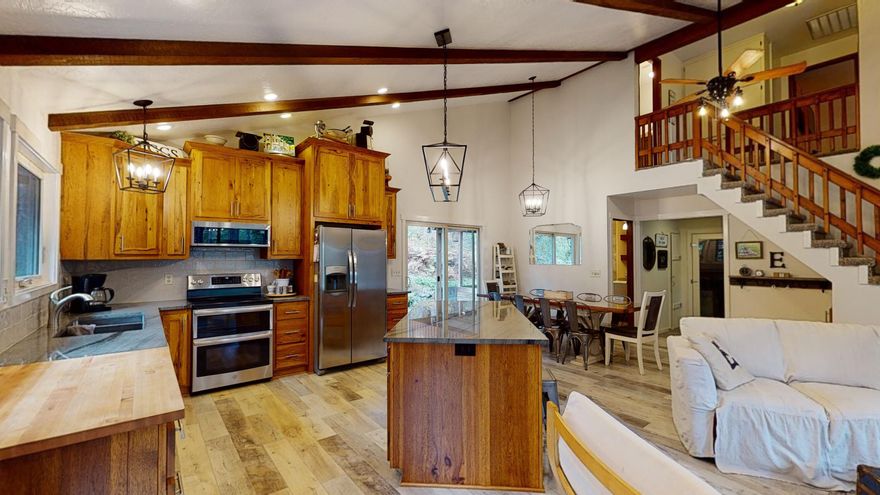 Watch the seasons unfold on this wooded, semi-private 3.08 acres. 4 bdrm, 2 bath, 2589 sq ft custom built home. Recently remodeled with a brand new kitchen featuring Quartzite counter tops, hickory cabinets, & stainless steel appliances. New carpet, travertine, tile, and laminate flooring throughout the home. Newer roof, certified wood stove. Large shop with enclosed in bedroom, full bath, and upstairs storage. Covered area of the north side of shop that could be utilized as RV parking complete RV dump and Hook Ups. Landscaped with automated sprinklers in front and backyard, plum and fig tree. All information is deemed reliable, and not verified.