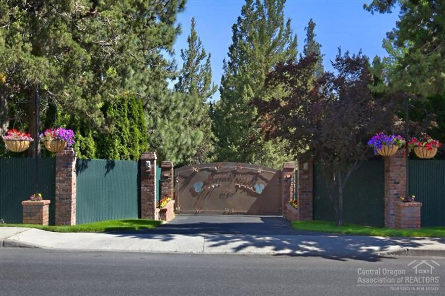 Squirrels Nest Estate in the heart of Bend; unique, private & gated, impeccable park-like grounds. Home features custom hickory cabinets & built-ins throughout, solid teak floors, gourmet kitchen & 4 fireplaces. Updated w/Jeld-Wen custom doors & windows & 3 zone heating/AC. Large deck, extensive security system w/cameras, oversized 2 car garage, 2,925 SF. RV bldg/shop w/RV hookups, 2 additional outbuildings plus separate 3 bd, 2 ba guest cottage. Incredible possibilities offered in this unique property.