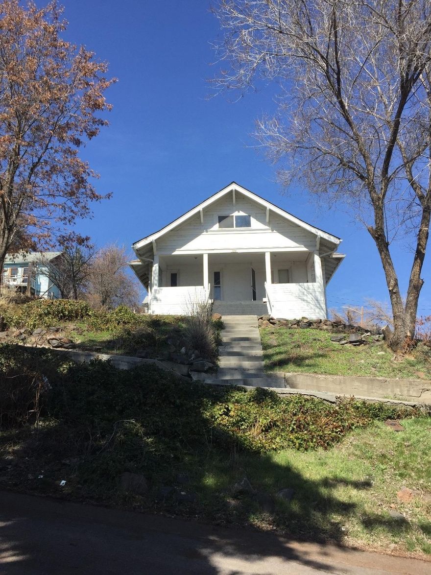 Beautiful, Craftsman Home with Awesome Views of the City lights and Mountains. Arched Doorways, Tall Ceilings and Fantastic Covered Porch. Large two car garage off street parking on 7th street. House has been started to be renovated. Close to Ragland Theater and down town. New Carpet and New Paint make sure you stop by and see the upgrades they are making!