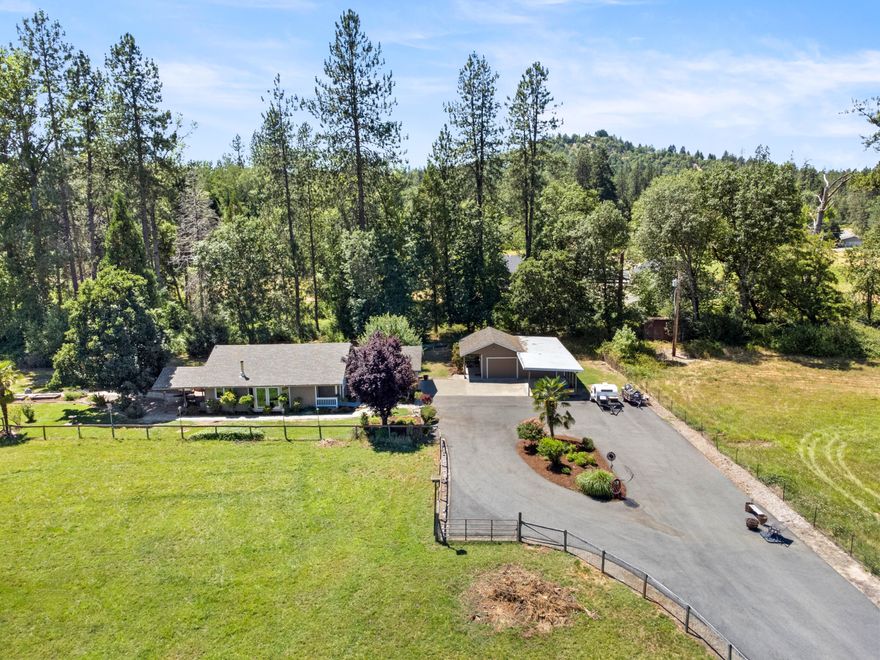 Tucked back off the main road, this charming countryside home offers a quiet and serene setting complete with a pasture, garden, and a hot tub on the patio, making it the perfect retreat for those seeking peace and tranquility. 
There are ramps in both the front and back of the home and wide doorways, allowing accessibility for everyone. 
As you enter the home, you'll notice the picture windows and woodstove, making this the perfect home no matter the weather. 
The new roof, new windows, fresh paint, gorgeous landscaping, a fenced yard, irrigated pasture, and plenty of parking (a garage, carpoort, and RV parking!) complete this move-in ready property.