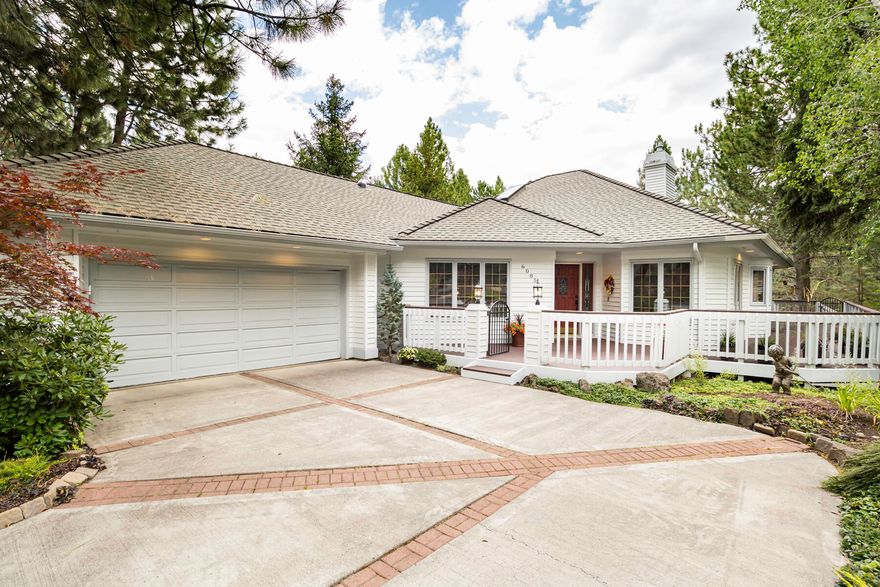 This wonderful single level property in a park like setting has elevated views of the golf course through the forest for a very private feel. open floor plan with real hardwood floors, separate gathering areas and a double sided fireplace creates a fantastic atmosphere for entertaining and everyday living. Kitchen w/stainless steel appliances and cabinets galore.  Expansive and private back deck is perfect for relaxing or dining outdoors. Spacious primary suite w/walkin closet. An additional suite, 3rd bedroom could have a built-in murphy bed. Laundry room with sink and craft room or office. Two car garage with plenty of storage.