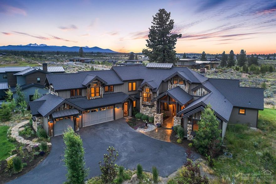 Stunning home on one of Tetherow's most desired streets. This home showcases beautiful Cascade Mountain views & attention to detail at every turn w/ high ceilings, exposed beams, huge stacked stone fireplace, tasteful use of barn-wood & stone accents throughout, two main level master suites, a bonus room, an oversized 3 car garage and so much more. The gourmet, professional grade kitchen is a chef's dream & entertaining is perfect on the back patio complete w/ gas fire-pit to sit & enjoy the views.