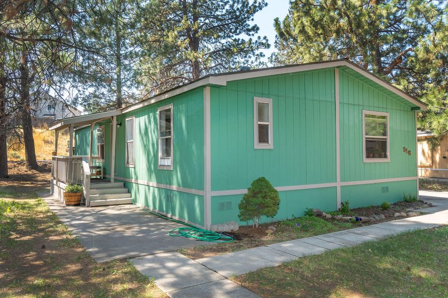 $10k buyer credit w/acceptable offer, and seller will consider offer for owner to carry! Charming 3 bedroom, 2 bath home with 1,344 sq.ft. located in SE Bend. Home features living room and family room space, w/vaulted ceilings for a spacious feel. Open floor plan with separation between primary and the other two bedrooms. Recent updates include newer laminate flooring throughout, interior paint, updated countertops, and renovated bathrooms with new tub, sinks, and shower enclosure. Forced air heating, for year-round comfort. You'll enjoy the large yard space both in the front and back. The covered front deck entry provides a cozy spot for relaxation. Additional features include a storage shed, attached carport w/access to laundry/mud room, deep driveway for ample parking. Roof is approx. 7 yrs new. Residents have access to a community clubhouse, playground, & sport court. Located close to schools, Alpenglow park, shopping and hwy/parkway acce