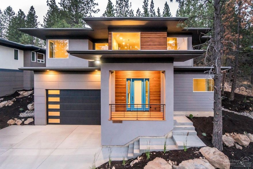 Striking mid-century modern, newly constructed home in fabulous West end location! Sits high above Century Drive amongst the rimrock and Pine trees, easy access to Mt. Bachelor and Phil's Trail! 9 ft ceilings with huge windows that take in beautiful private views and light. Main level has 3 bedrooms, 1 bath and mudroom. Upper level has Great Room, Master Suite with soaking tub/separate shower+walk-in closet, large office, laundry room. High-end finishes include engineered hardwood, shining concrete floors, quartz countertops, Chefs kitchen with 5 burner 36 inch gas cooktop and step-in pantry, modern gas fireplace in living room with floating hearth. 3-car tandem garage with 10 ft door and large storage room perfect for wine cellar! This home is Earth Advantage Certified for optimal energy conservation. Please be sure to click on Virtual Media for a complete video tour of the home!