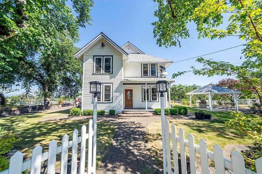 2 homes on over 55+ EFU acres with 35 irrigated for this storybook setting of mature trees including 4 Siberian Elms, lawn areas, stone walkways & vast views. Circa 1900 built gracious Farm House with original ornate woodwork. Spacious rooms, large windows & views in all directions. Covered porch leads to living room which opens to large family room, formal dining & large kitchen. The kitchen has Corian counters, stainless appliances, island, 2 built-in buffets & sizable informal dining. Separate office & full bath plus laundry on main level. Upper-level features 4 bedrooms & 2 baths. 3 car garage for main house, huge 1488 sf shop, RV covered parking, play area, large paver patio & 13 planter beds. 2nd residence at 499 Meridian has a darling ranch style home with 2 bedrooms, newer quality laminate flooring, cute kitchen with dining, remodeled bath, covered gazebo, pastures, 2021 built 4 car garage, 25x30 shop with 110 & 220. Both homes are on one tax lot. This is a fantastic property!