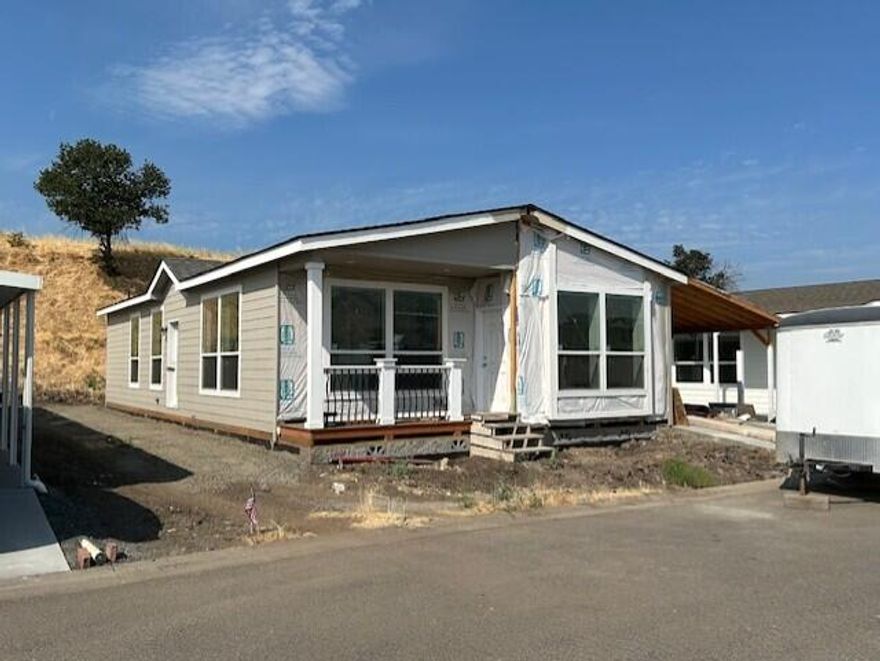 Here's a new listing #59 in popular Mountain View Estates, a 55+ community. Mountain View Estates is still owned by the local family that developed it in 1987. 21 homes of the 164 homes survived the Alameda Fire of 2020. The park is being restored & is now welcoming new and returning residents to this vibrant community. There's a brand-new dog park and mailbox kiosk with parking at the entry. This brand-new Skyline 3 bedroom, 2 bath home is just the right size. The large main bedroom has trayed ceilings. Double vanity in the bathroom with a step-in shower & linen closet. The kitchen & living area are in the front with views of the neighborhood. There are plenty of counters, cabinets, pantry & center island to please the cook. You've got plenty of space for your cars under the carport. Vinyl fencing & drought tolerant landscaping included along with sewer & trash. One small pet up to 25 lbs allowed. Interesting? You bet.